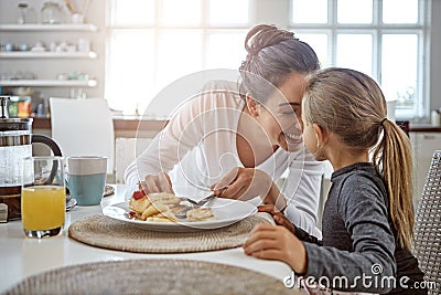 Theres no love greater...a mother and daughter having breakfast at home. Stock Photo