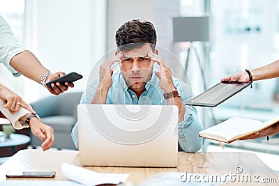 Theres too much to do, and too little time. a young businessman looking stressed out in a demanding office environment. Stock Photo
