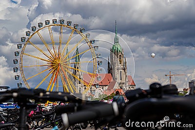 theresienwiese, munich, germany, 2019 april 27: St Paul church with ferris wheel in the background from the flea market in bavaria Cartoon Illustration