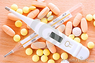 Thermometer and pills Stock Photo