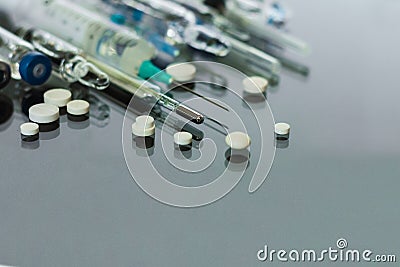 Thermometer, pills, injection vaccine ampoules, syringe for vaccination on glass background, Coronavirus, MERS-CoV, air Stock Photo