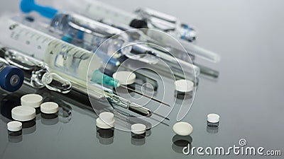 Thermometer, pills, injection vaccineampoules, syringe for vaccination on glass background, medicine concept background, Stock Photo