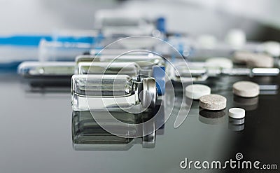 Thermometer, pills, injection vaccineampoules, syringe for vaccination on glass background, medicine concept background, Stock Photo