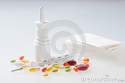 Thermometer, pills, nasal spray and used tissues on white background. Cold and flu concept Stock Photo