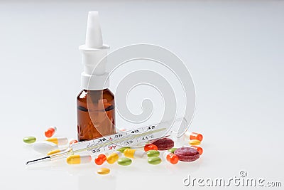 Thermometer, pills, nasal spray on white. Cold and flu concept Stock Photo