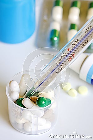 Thermometer and pills pharmaceuticals concept Stock Photo