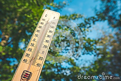 Thermometer shows higt temperatures in celsius or farenheit. Stock Photo