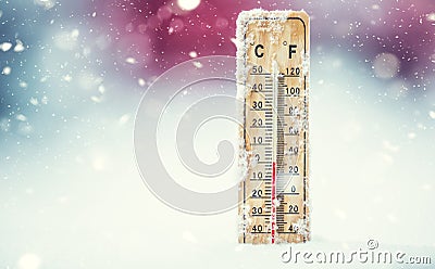 Thermometer on snow shows low temperatures in celsius or farenheit Stock Photo