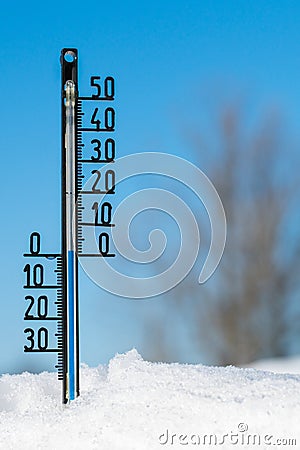 Thermometer on snow shows low temperatures Stock Photo