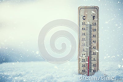 Thermometer on snow shows low temperatures under zero. Low tempe Stock Photo