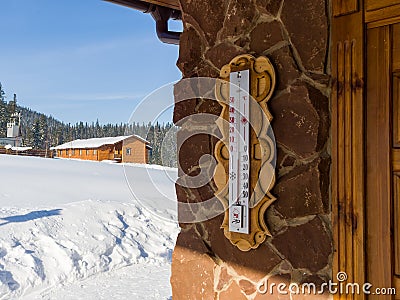 Thermometer on a stone wall. Winter sunny day at the ski resort Stock Photo