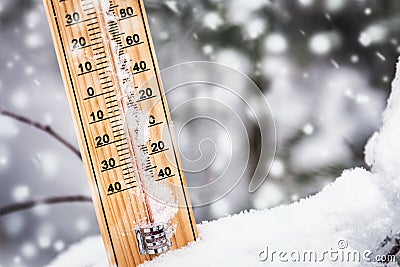 Thermometer with subzero temperature stuck in the snow Stock Photo
