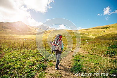 Thermos in the forest, drinking tea on green hills. Water running down, small river. Nature travel russia Stock Photo