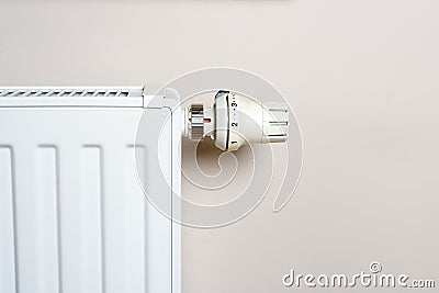 Thermostat and radiator on wall Stock Photo