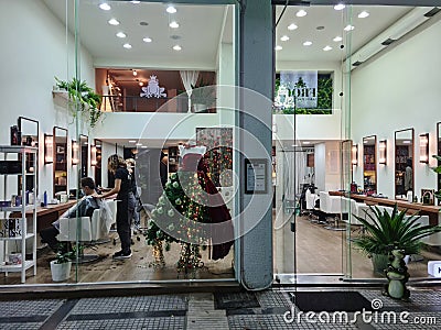 Thessaloniki, Greece Hairdresser cutting hair of male wearing covid-19 mask. Editorial Stock Photo