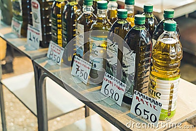 07.13.2022 Thessaloniki, Greece. Different kinds of pure Greek olive oil in plastic and glass transparent bottles with Editorial Stock Photo