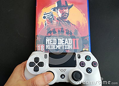 Thessaloniki, Greece, February 11, 2020: The New Red Dead Redemption 2 game with ps4 v2 white Joystick on black Editorial Stock Photo