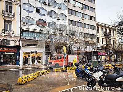Thessaloniki, Greece Fire brigade servicemen with yellow protective coats cutting tree branches in the city center Editorial Stock Photo
