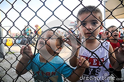 Refugee children disembark in the port of Thessaloniki after being transfered from the refugee camp of Moria, Lesvos island Editorial Stock Photo