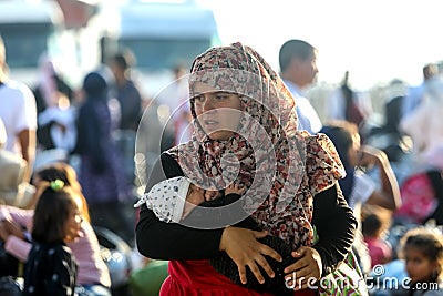 Refugees and migrants disembark to the port of Thessaloniki after being transfered from the refugee camp of Moria, Lesvos island Editorial Stock Photo