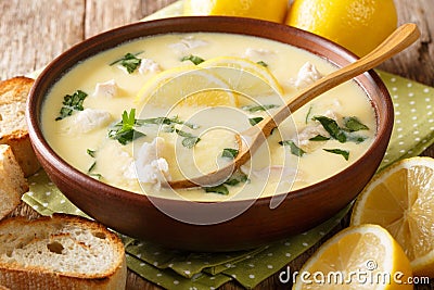 Thick aromatic Greek lemon soup with chicken and orzo paste close-up in a bowl. horizontal Stock Photo