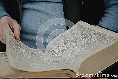 Thick book in hands of man Stock Photo