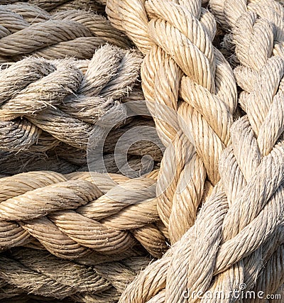 Thick braided rope is tied with a skein. Fishing rope background. Stock Photo