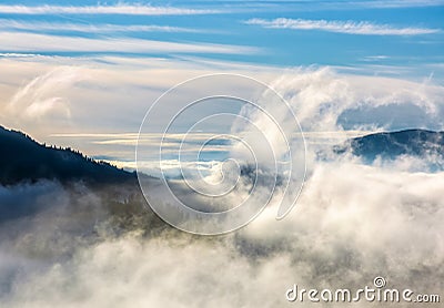 Thick cloud formation rising from the valley Stock Photo