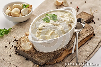 Thick creamy sauce with mushrooms Stock Photo