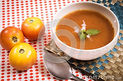 Thick creamy tomato soup served hot in a soup bowl. Hot tomato soup in a bowl Stock Photo