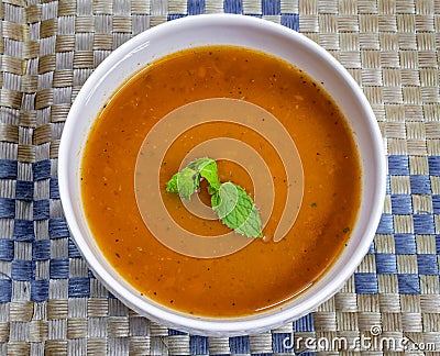 Thick creamy tomato soup served hot in a soup bowl. Hot tomato soup in a bowl Stock Photo