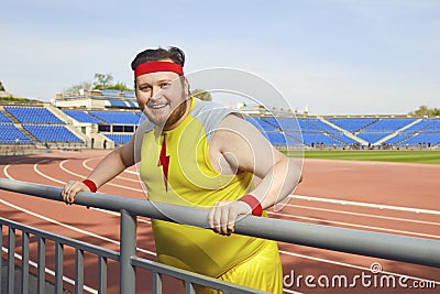 Thick funny man resting after a workout at the stadium. Stock Photo