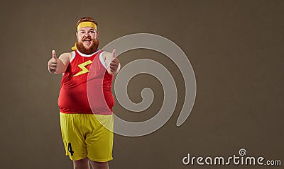 Thick funny man in sportswear keeps his fingers up Stock Photo