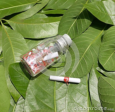 Thick Glass Jars with littel white latter on the leaf background Stock Photo