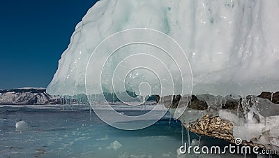 A thick layer of ice covers the base of the rock Stock Photo