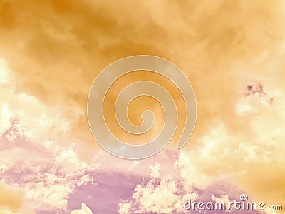 Thick orange clouds floated across the pale pink sky Stock Photo