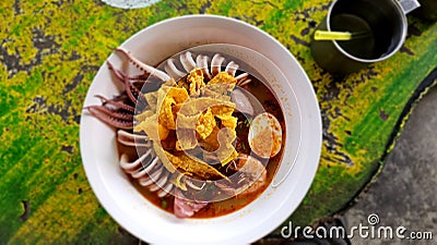 Thick seafood noodles consisting of squid noodles, boiled eggs, colorful and appetizing. Stock Photo