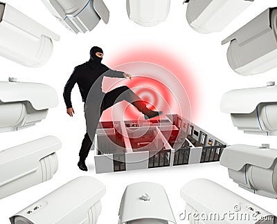 Thief with balaclava is ready to rob an apartment but it is controlled by video surveillance cameras Stock Photo