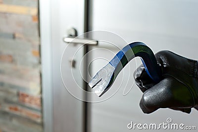 Thief with a bar of iron Stock Photo