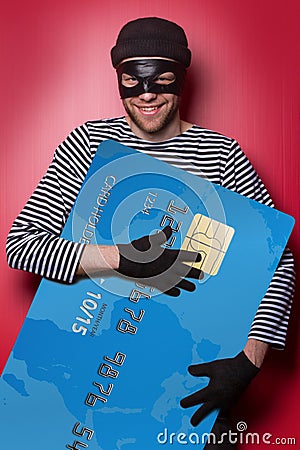 Thief with big blue credit card Stock Photo