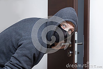 Thief opening door Stock Photo