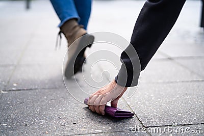 Thief Picking Lost Personal Wallet With Money Stock Photo