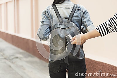 Thief stealing mobile from traveller bag on street. Picture for add text message. Backdrop for design art work Stock Photo