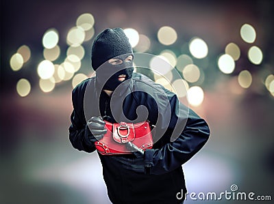 Thief stealing womans handbag Stock Photo