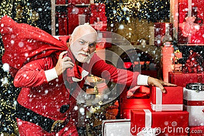 Thief stole new years presents. Criminal christmas. Criminal Santa Claus posing with a bag of christmas gifts. Stock Photo