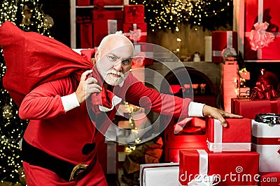 Thief stole new years presents. Criminal christmas. Criminal Santa Claus posing with a bag of christmas gifts. Stock Photo