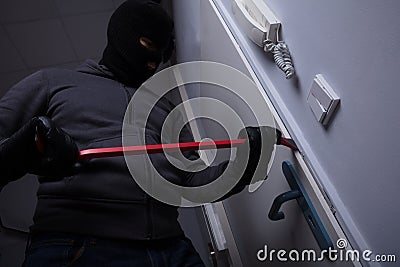 Thief Trying To Break The Door Stock Photo