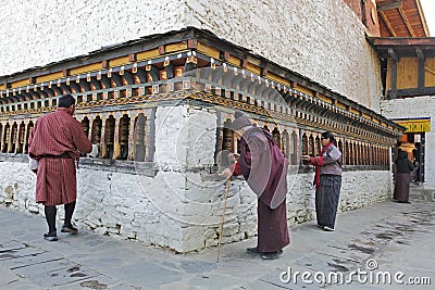 THIMPHU, BHUTAN - DEC 3, 2017: Pilgrims are spinning buddhist prayer wheels Editorial Stock Photo