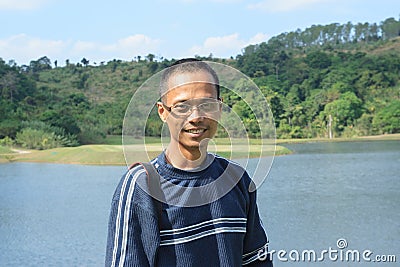 Thin asian man wearing eyes glass with skin head hair fashion sm Stock Photo