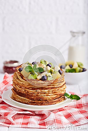 Thin crepe pancakes with fruits and berries. Crepe week. Stock Photo